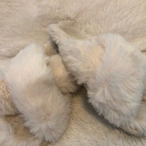 Soft white slippers from Target with a great color on the heel from wearing!